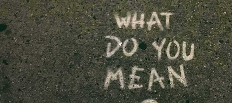 The words "What Do You Mean" written on a sidewalk.