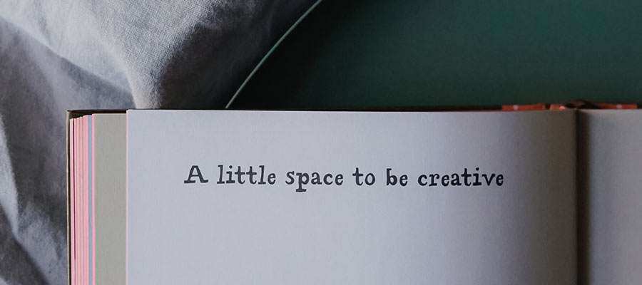 A book passage that reads, "A little space to be creative".