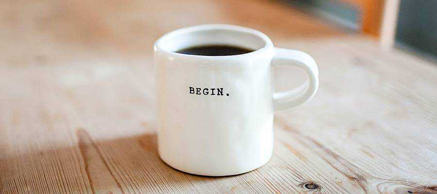 A coffee mug with "BEGIN" written on it.