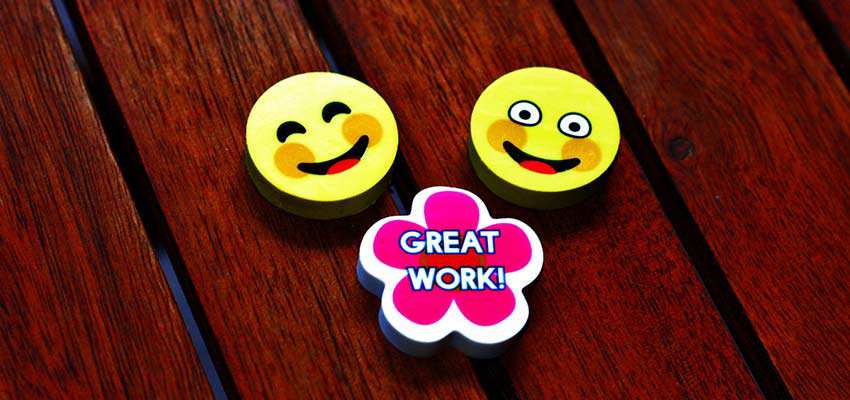Erasers with smiley faces and a badge that says "Great Work"